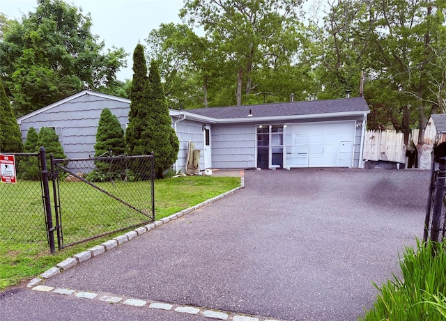 2 Pinetop Dr, Shirley, NY 11967 - view of front facade with driveway, an attached garage, and a gate