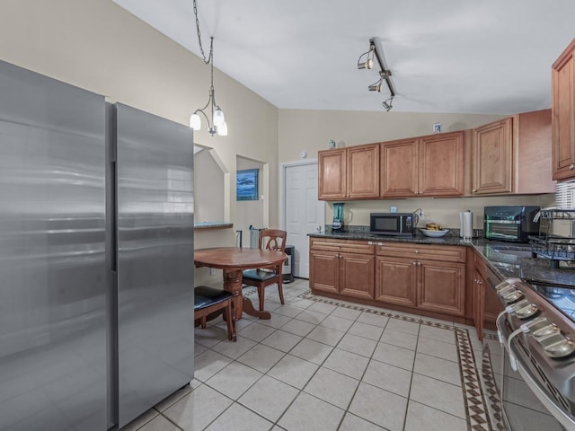 2 Pinetop Dr, Shirley, NY 11967 - kitchen featuring appliances with stainless steel finishes, lofted ceiling, light tile patterned floors, brown cabinets, and hanging light fixtures