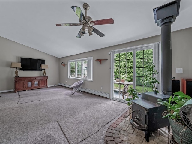 2 Pinetop Dr, Shirley, NY 11967 - carpeted living area with a wood stove, ceiling fan, lofted ceiling, and a baseboard radiator