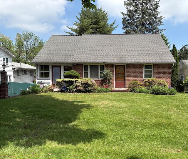 324 Westside Ave, Haverstraw, NY 10927 - view of front of home featuring a shingled roof, a front lawn, and brick siding