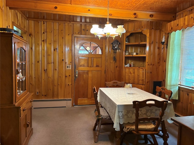 324 Westside Ave, Haverstraw, NY 10927 - dining space with wooden walls, a chandelier, baseboard heating, and carpet flooring
