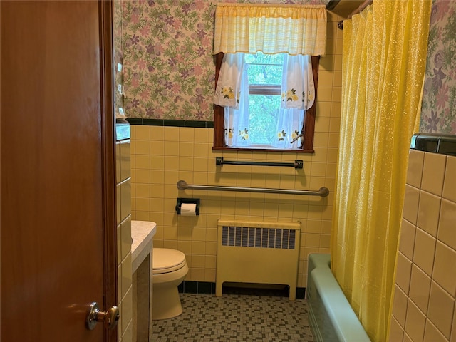 324 Westside Ave, Haverstraw, NY 10927 - bathroom with radiator heating unit, wallpapered walls, tile walls, a wainscoted wall, and toilet