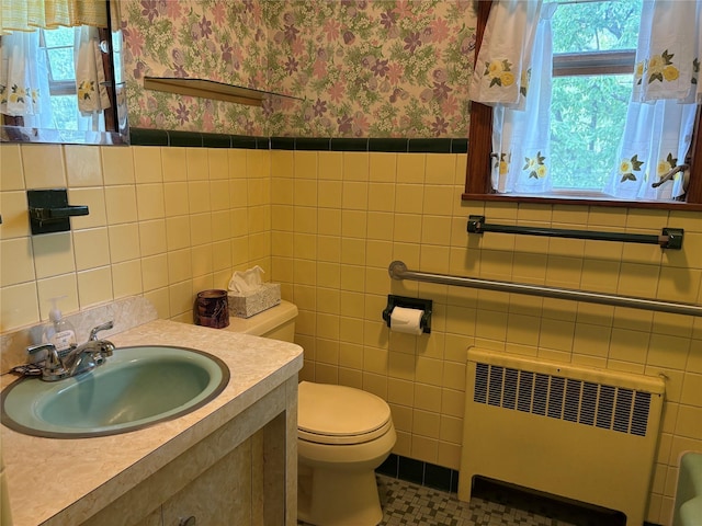324 Westside Ave, Haverstraw, NY 10927 - half bath with radiator, wallpapered walls, healthy amount of natural light, toilet, and vanity