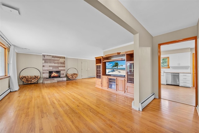 38 Degarmo Hills Rd, Wappingers Falls, NY 12590 - unfurnished living room featuring a baseboard heating unit, light wood-style flooring, a stone fireplace, crown molding, and baseboards