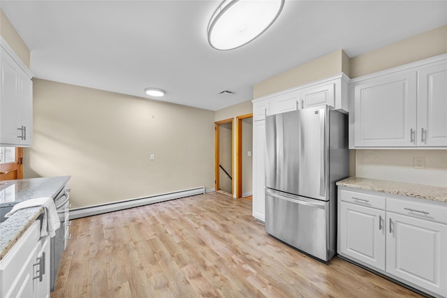 38 Degarmo Hills Rd, Wappingers Falls, NY 12590 - kitchen featuring freestanding refrigerator, white cabinets, a baseboard heating unit, and light wood-style floors