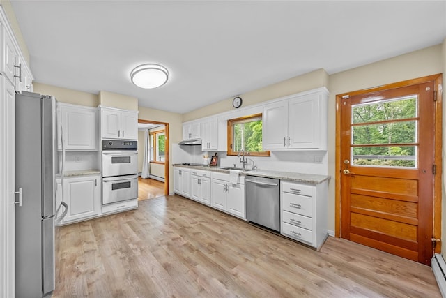 38 Degarmo Hills Rd, Wappingers Falls, NY 12590 - kitchen featuring appliances with stainless steel finishes, a sink, white cabinets, light wood-style floors, and light stone countertops