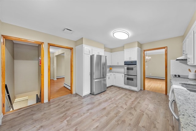 38 Degarmo Hills Rd, Wappingers Falls, NY 12590 - kitchen with stainless steel appliances, under cabinet range hood, baseboard heating, white cabinetry, and light wood-type flooring