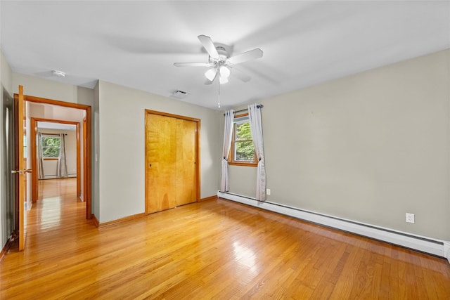38 Degarmo Hills Rd, Wappingers Falls, NY 12590 - unfurnished bedroom with a baseboard radiator, light wood-style flooring, a closet, baseboards, and a ceiling fan