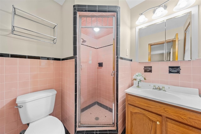 38 Degarmo Hills Rd, Wappingers Falls, NY 12590 - bathroom featuring tile walls, toilet, vanity, a shower stall, and a wainscoted wall