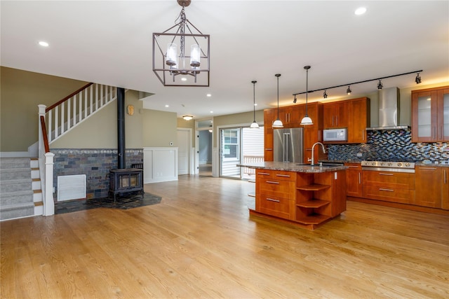 22 Commonwealth Ave, Massapequa, NY 11758 - kitchen featuring appliances with stainless steel finishes, wall chimney exhaust hood, a sink, open shelves, and brown cabinets