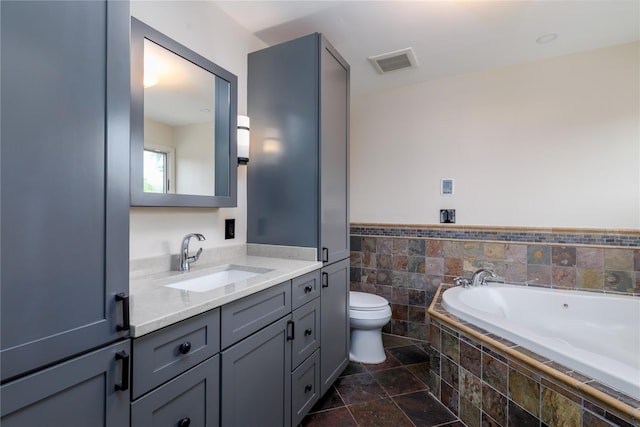 22 Commonwealth Ave, Massapequa, NY 11758 - full bath with vanity, toilet, a garden tub, stone tile flooring, and a wainscoted wall