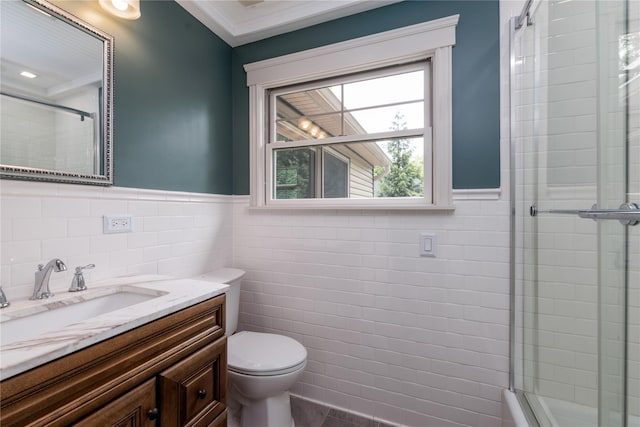 22 Commonwealth Ave, Massapequa, NY 11758 - full bathroom with tile walls, toilet, tiled shower, a wainscoted wall, and vanity
