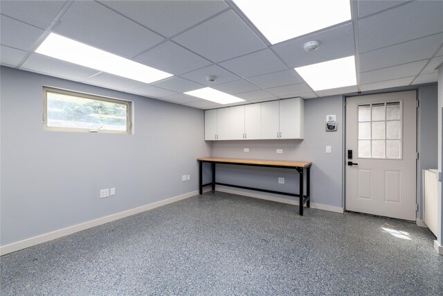 22 Commonwealth Ave, Massapequa, NY 11758 - below grade area with baseboards and a drop ceiling