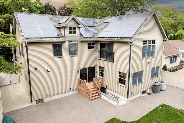22 Commonwealth Ave, Massapequa, NY 11758 - back of house with solar panels, a patio area, and central air condition unit