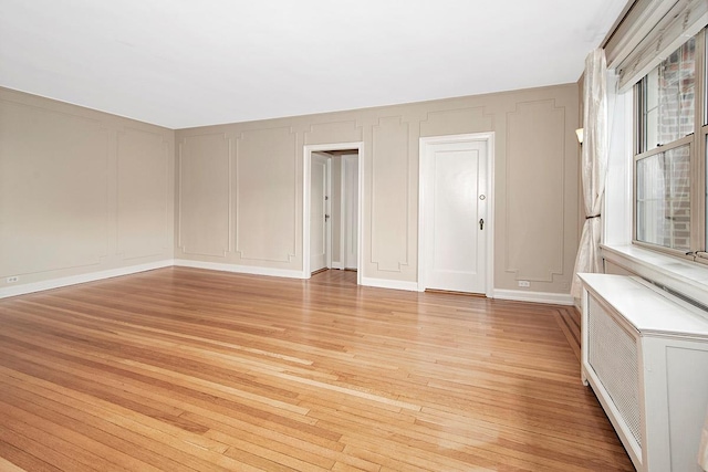 151 Centre Ave Unit 5D, New Rochelle, NY 10805 - unfurnished room featuring a decorative wall and light wood finished floors
