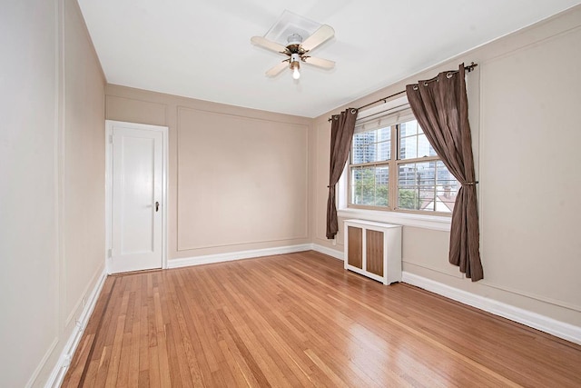 151 Centre Ave Unit 5D, New Rochelle, NY 10805 - empty room with radiator, light wood-style floors, ceiling fan, and baseboards