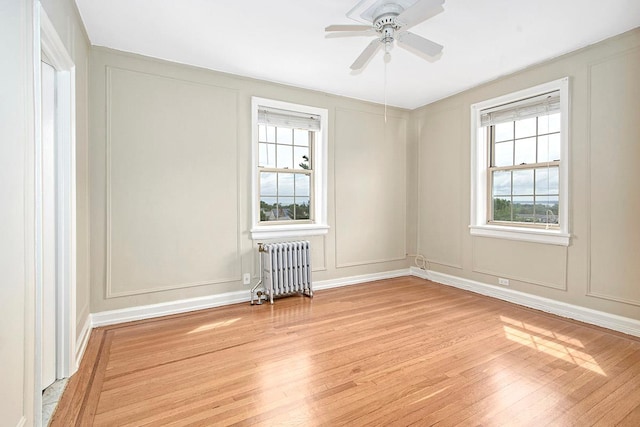 151 Centre Ave Unit 5D, New Rochelle, NY 10805 - unfurnished room with radiator heating unit, a decorative wall, light wood-style flooring, and ceiling fan
