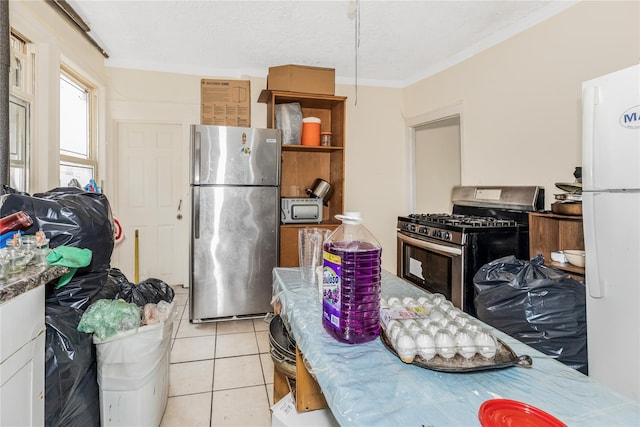 132 Oak St, Yonkers, NY 10701 - kitchen with stainless steel appliances, light tile patterned floors, and crown molding