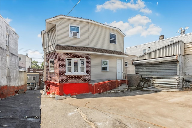 132 Oak St, Yonkers, NY 10701 - rear view of property featuring brick siding and roof with shingles