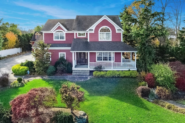 140 Grant Dr, Aquebogue, NY 11931 - view of front of house with a porch, a shingled roof, and a front lawn