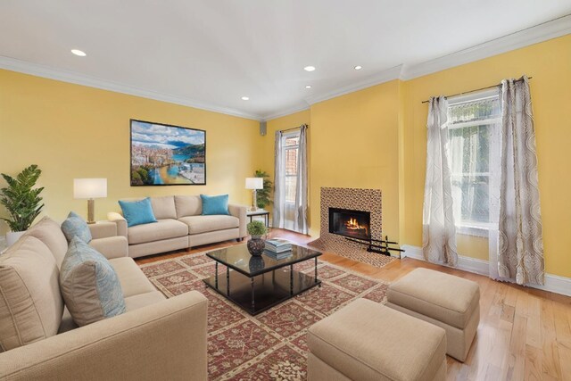 140 Grant Dr, Aquebogue, NY 11931 - living area with wood finished floors, healthy amount of natural light, recessed lighting, crown molding, and a fireplace