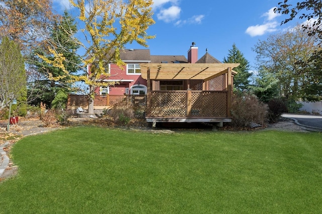 140 Grant Dr, Aquebogue, NY 11931 - back of property with a yard, a chimney, and a wooden deck