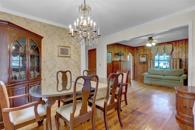 690 Franklin Ave, Massapequa, NY 11758 - dining space with wallpapered walls, wood finished floors, ceiling fan, crown molding, and a chandelier