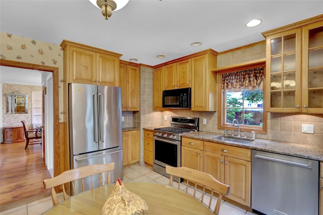 690 Franklin Ave, Massapequa, NY 11758 - kitchen featuring stainless steel appliances, a sink, wallpapered walls, light stone counters, and decorative backsplash