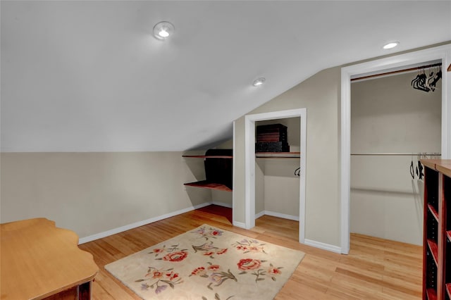 690 Franklin Ave, Massapequa, NY 11758 - additional living space with vaulted ceiling, wood finished floors, baseboards, and recessed lighting