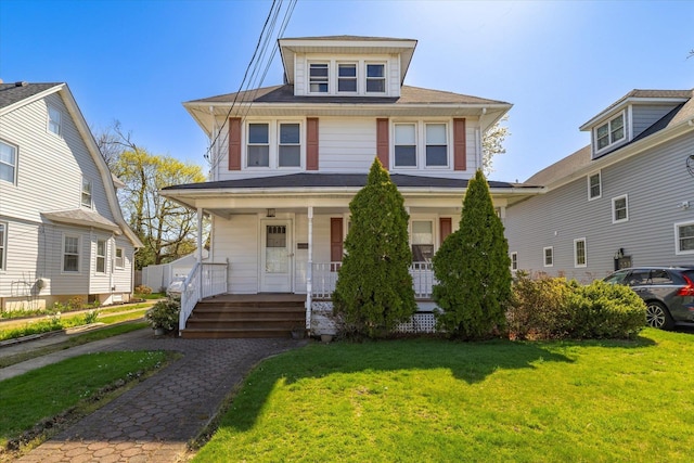 81 Liberty Ave, Rockville Centre, NY 11570 - american foursquare style home featuring a porch and a front yard