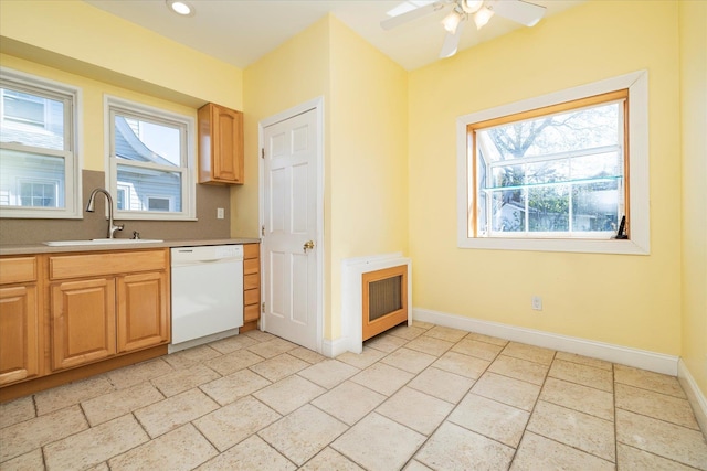 81 Liberty Ave, Rockville Centre, NY 11570 - kitchen with white dishwasher, a sink, ceiling fan, light countertops, and baseboards