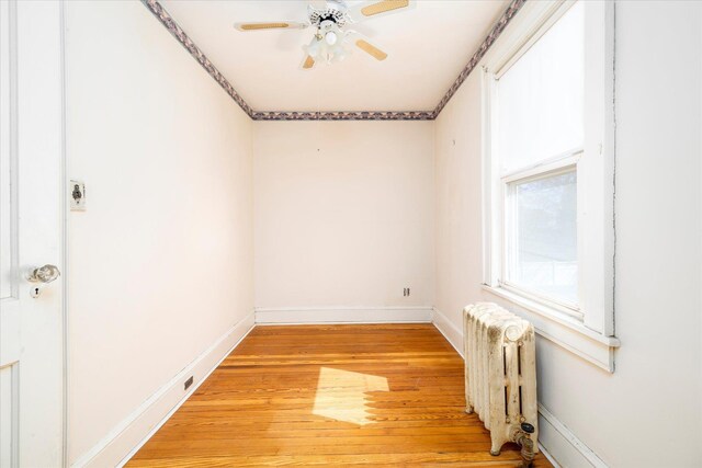 81 Liberty Ave, Rockville Centre, NY 11570 - spare room featuring radiator heating unit, light wood-type flooring, a ceiling fan, and baseboards
