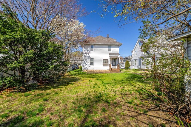 81 Liberty Ave, Rockville Centre, NY 11570 - back of property featuring a lawn and entry steps
