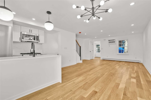 3951 45th St Unit 1, Sunnyside, NY 11104 - unfurnished living room with a baseboard radiator, recessed lighting, stairs, light wood finished floors, and a wall mounted AC