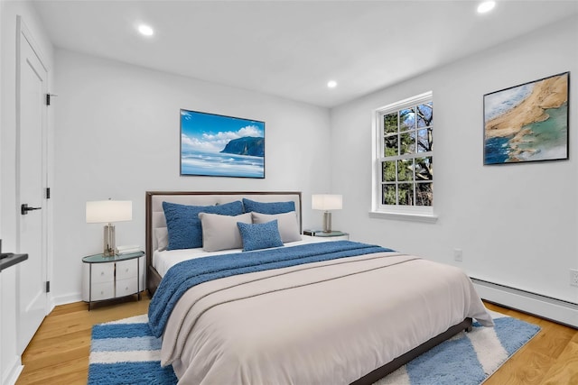 3951 45th St Unit 1, Sunnyside, NY 11104 - bedroom with a baseboard heating unit, wood finished floors, recessed lighting, and baseboards