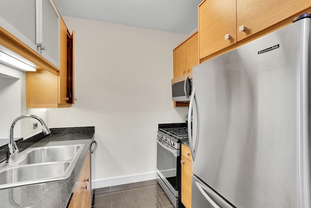 120 Riverside Blvd Unit 10T, New York Manhattan, NY 10069 - kitchen with appliances with stainless steel finishes, a sink, dark countertops, and baseboards