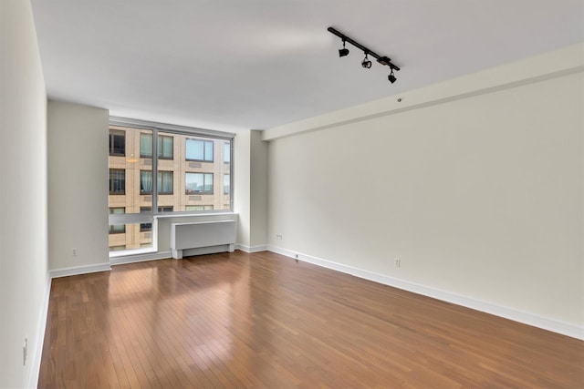 120 Riverside Blvd Unit 10T, New York Manhattan, NY 10069 - unfurnished room with track lighting, dark wood-style flooring, and baseboards