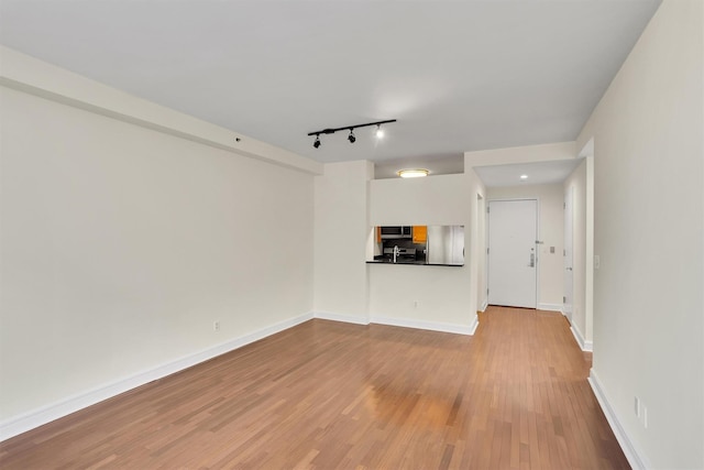 120 Riverside Blvd Unit 10T, New York Manhattan, NY 10069 - unfurnished living room with rail lighting, wood finished floors, and baseboards