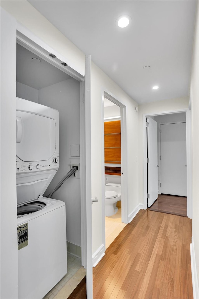 120 Riverside Blvd Unit 10T, New York Manhattan, NY 10069 - laundry area featuring stacked washer / drying machine, light wood-style floors, recessed lighting, and baseboards