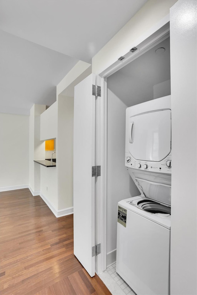 120 Riverside Blvd Unit 10T, New York Manhattan, NY 10069 - washroom featuring stacked washer and clothes dryer, wood finished floors, and baseboards