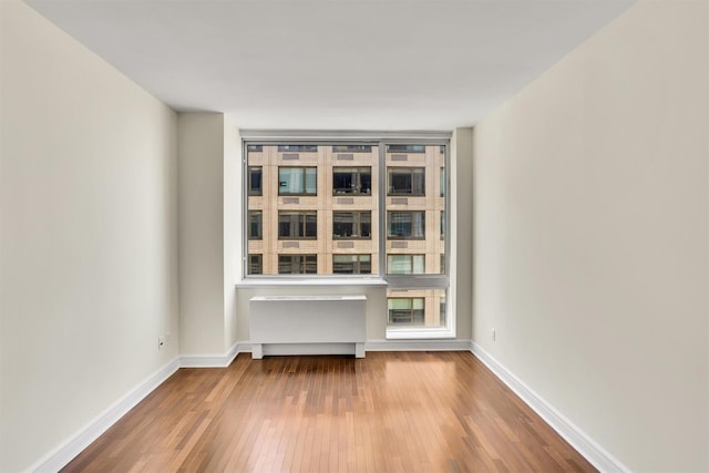 120 Riverside Blvd Unit 10T, New York Manhattan, NY 10069 - unfurnished room with hardwood / wood-style flooring, baseboards, and radiator heating unit
