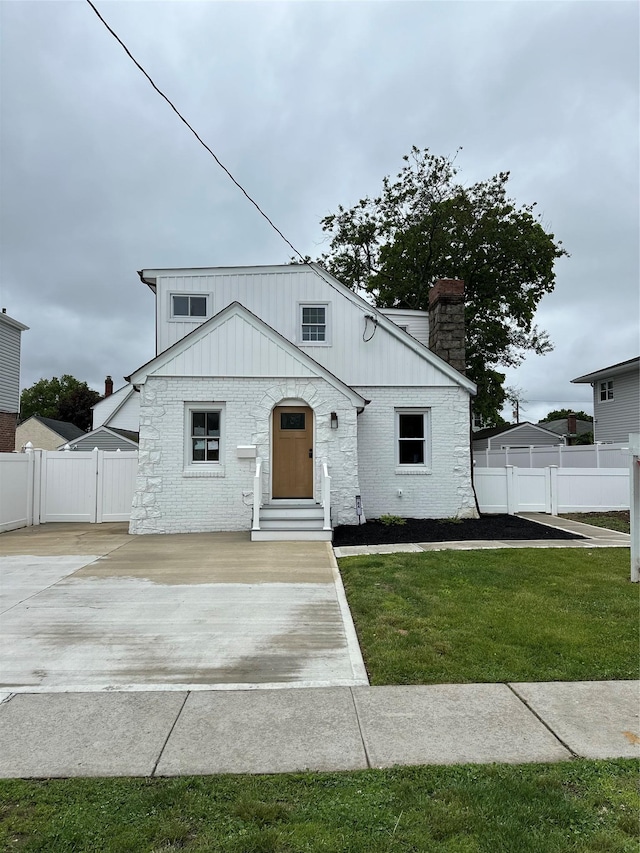 84 Windsor, Hempstead, NY 11550 - view of front of property with a chimney