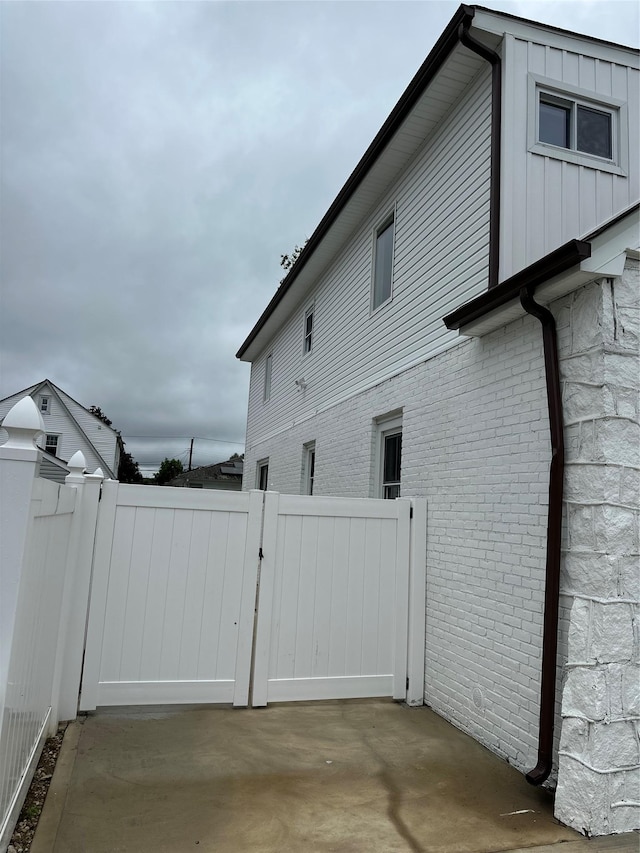 84 Windsor, Hempstead, NY 11550 - view of home's exterior with a gate and brick siding