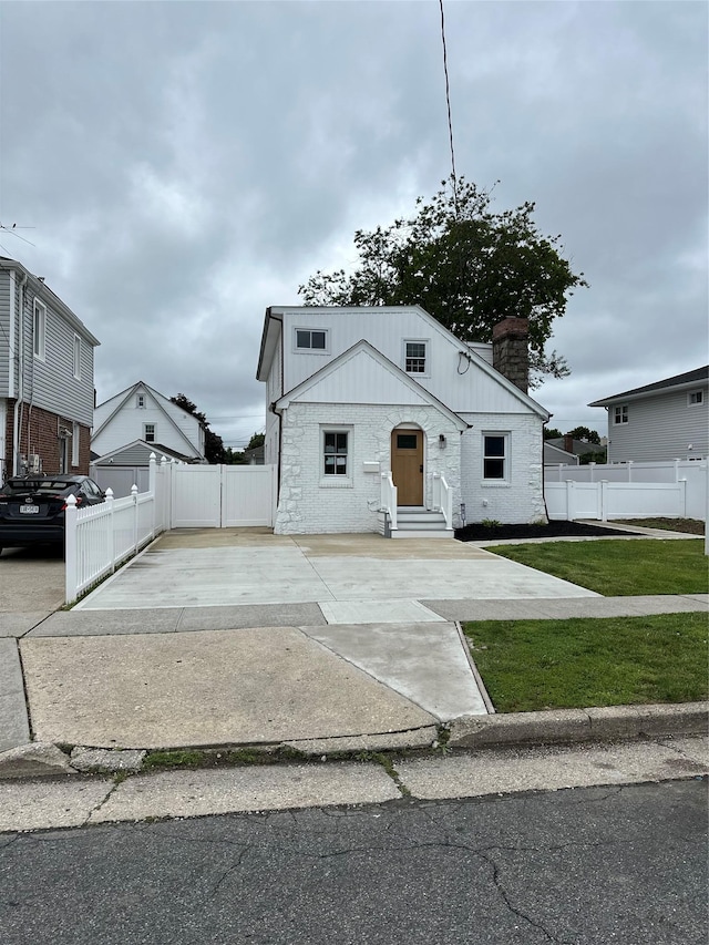 84 Windsor, Hempstead, NY 11550 - view of front of home with a chimney, entry steps, and stone siding