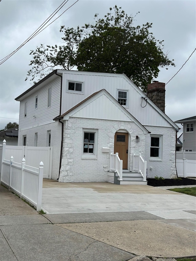 84 Windsor, Hempstead, NY 11550 - view of front of home featuring a chimney and brick siding