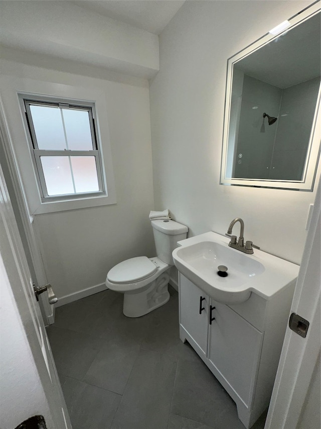 84 Windsor, Hempstead, NY 11550 - bathroom featuring vanity, toilet, tile patterned floors, and baseboards