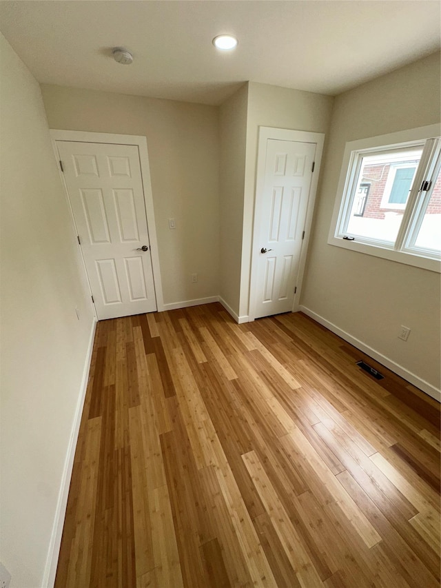 84 Windsor, Hempstead, NY 11550 - unfurnished bedroom featuring light wood finished floors, baseboards, and recessed lighting