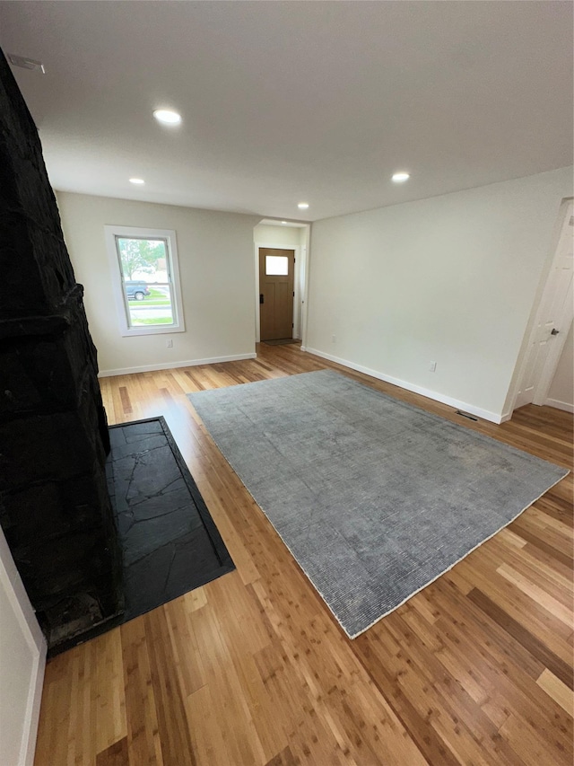 84 Windsor, Hempstead, NY 11550 - unfurnished living room featuring wood finished floors, recessed lighting, and baseboards