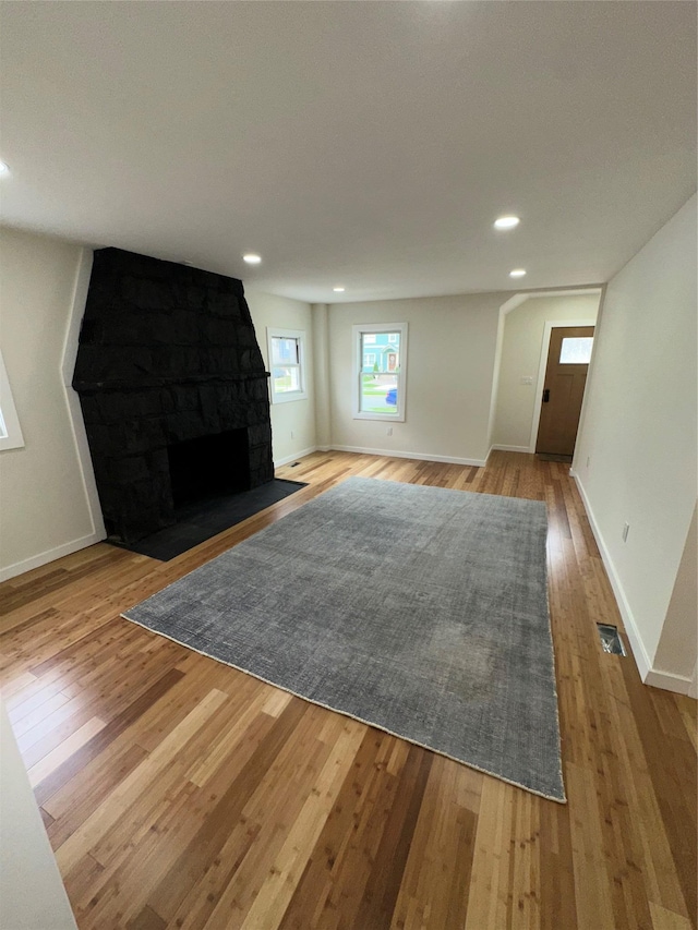 84 Windsor, Hempstead, NY 11550 - unfurnished living room with hardwood / wood-style flooring, baseboards, a fireplace, and recessed lighting