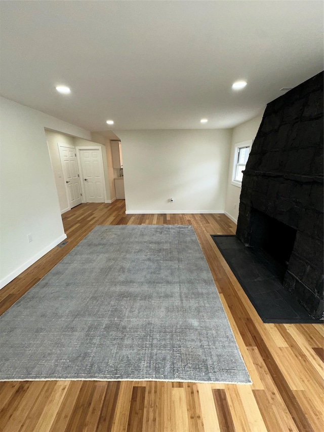 84 Windsor, Hempstead, NY 11550 - unfurnished living room with wood finished floors, a fireplace, baseboards, and recessed lighting